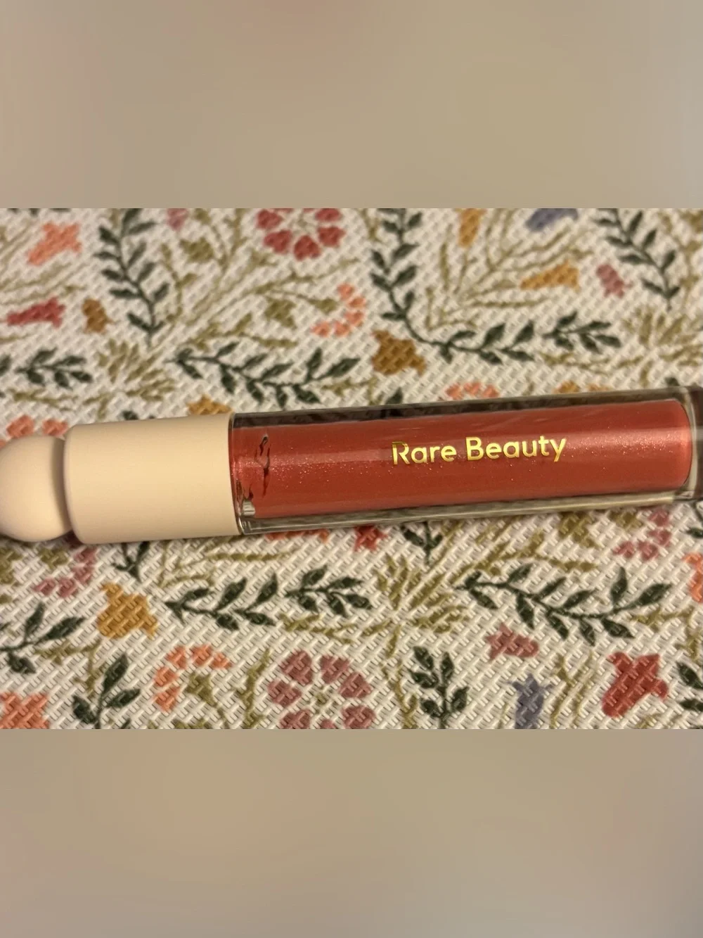 Rare Beauty Glimmer Lip Gloss in Shimmery Deep Coral Pink